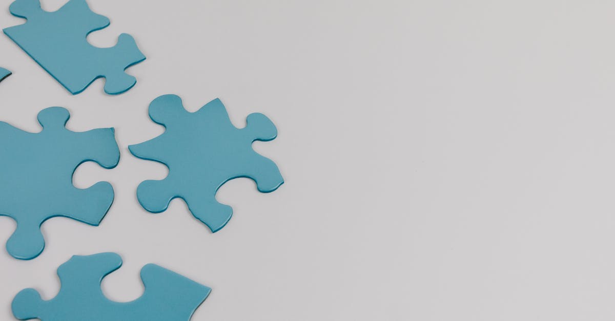 Close-up of blue puzzle pieces on a white background with copy space.